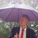 Businessman Sheltering Underneath an Umbrella in the Rain - VideoHive Item for Sale