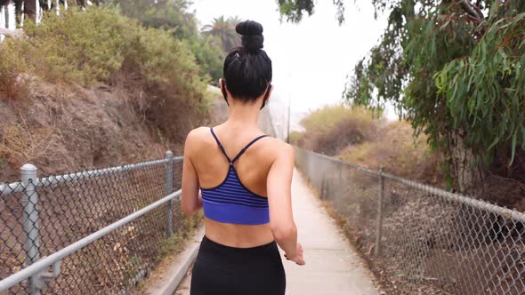 Athletic Asian woman going for her morning workout