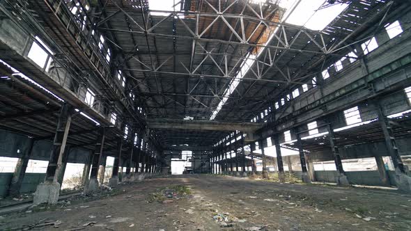 Large abandoned industrial hall. Territory of abandoned industrial area waiting for demolition