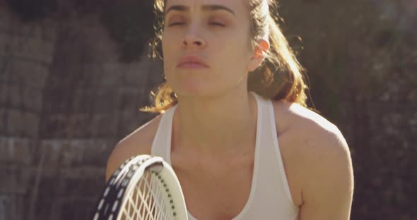 Woman playing tennis on a sunny day