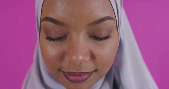 Close Up Shot of Young Modern Muslim Afro Beauty Wearing Traditional Islamic Clothes on Plastic Pink