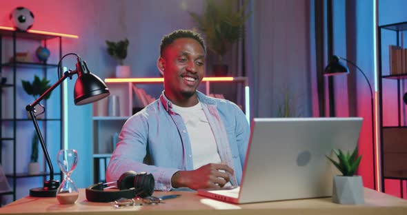 Black-Skinned Guy which Sitting in front of Computer During Video Chat