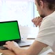 Handsome Specialist Working on Laptop Computer with Green Screen Mock Up Display at Home - VideoHive Item for Sale