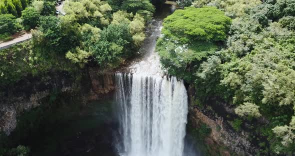 Drone shot moving towards a waterfall.