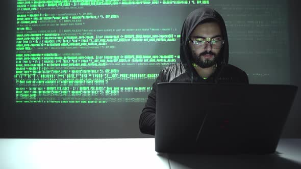 cybersecurity concept. hacker stealing information from his laptop with copyspace