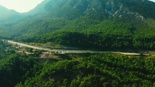Aerial View From Above of Country Road Through Wooded Mountains