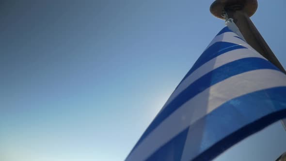 Greek Flag Waving in the Wind on Sky Background alt