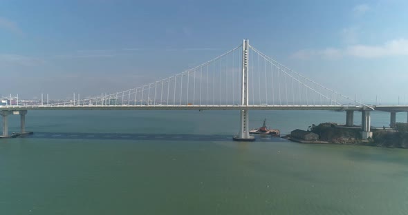 Aerial shot of vehicles moving on San Francisco–Oakland Bay Bridge with city in background