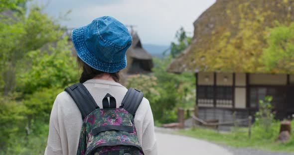 Woman travel in the countryside in Japan and use phone to take photo