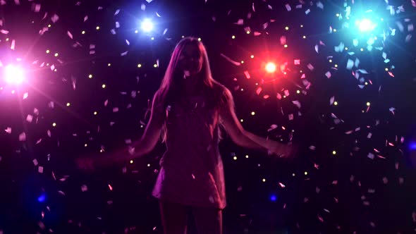 Silhouette of Dancing Girl with Disco Style Lights and Confetti