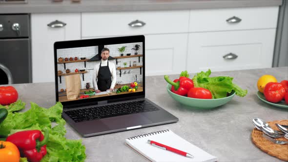 Close Up Laptop with Man Chef Food Blogger in Screen Tells Teaches Student