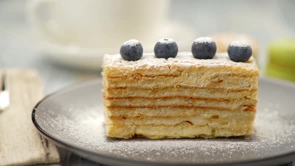 Yummy Sweet Baked Napoleon Cake on Grey Plate. Cake Decorated with Four Blueberries and Being