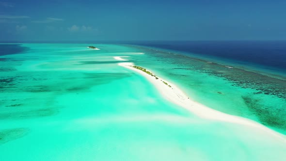 Aerial flying over panorama of paradise coast beach time by shallow lagoon and white sandy backgroun