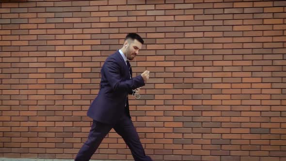 Happy Successful Businessman Dancing In Wireless Earphones