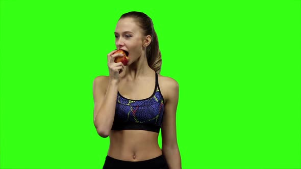 Woman Athlete with Apple. Slow Motion. Green Screen