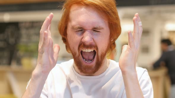 Portrait of Screaming Redhead Beard Man, Shouting in Cafe