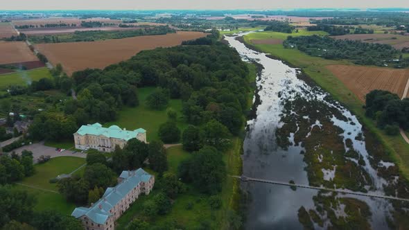Aerial Shot City Mezotne, Latvia Republic. Mezotne Palace and Park With Fountain. Lielupe River With
