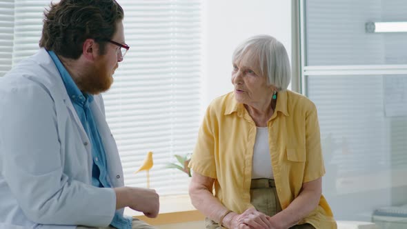 Eldelry Woman Speaking with Doctor in Clinic