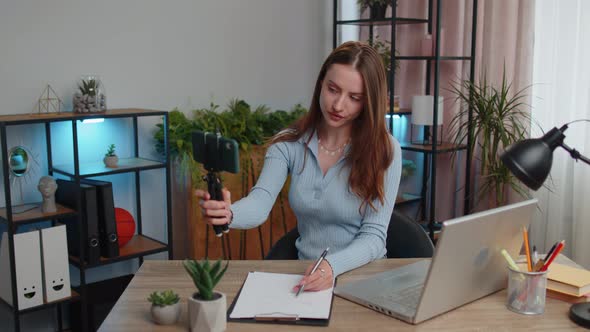 Young Business Woman Blogger Using Smartphone Shooting Video Call for Social Media at Home Office