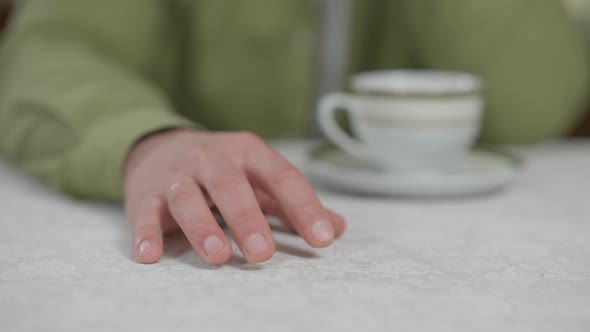 Hand of Impatient Nervous Caucasian Man Tapping Fingers on Table Indoors