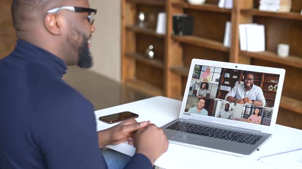 Male Businessman Leads Distant Communication with Colleagues