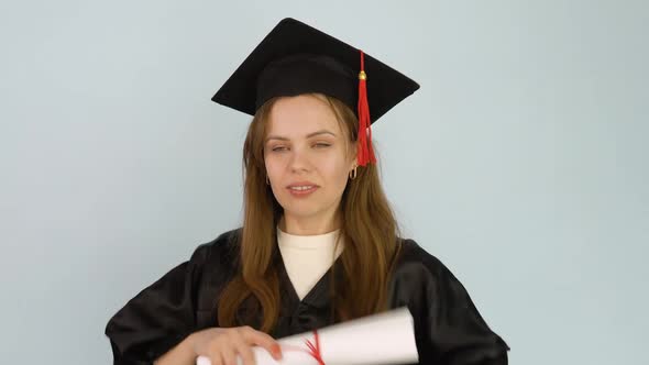 A University Graduate Dances with a Diploma in Her Hands