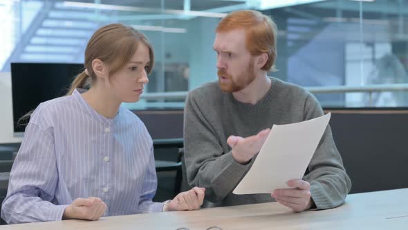 Young Man and Woman Having Loss While Reading Documents