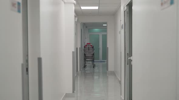 Empty Hospital Bed in the Corridor of an Empty Modern Clinic