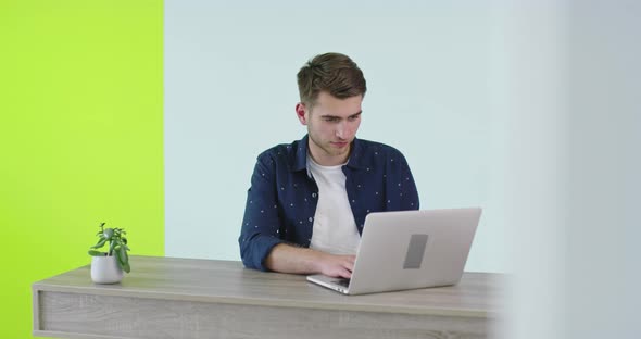 Freelance Career Smiling Man Working On Laptop Computer At Home