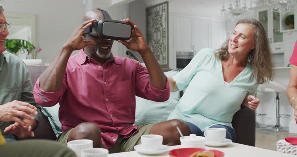 Animation of happy diverse female and male senior friends using vr headset and having fun