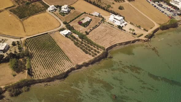 Establishing drone tilt shot from the Paros island coastline to the inland hills; Greece; aerial dro