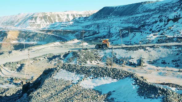 Truck Loaded with Ore is Riding Along the Mine Site