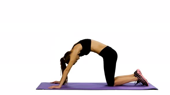 Young Woman Practicing Yoga in Gym, White Background