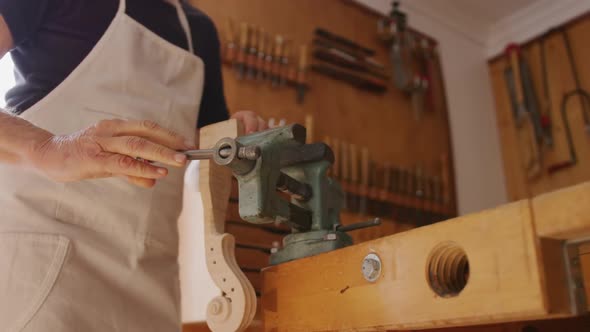 Female luthier at work in her workshop