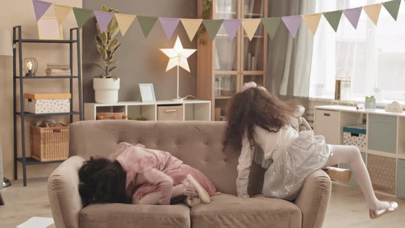 Little Sisters Rolling Around on Couch