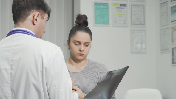 Worried Woman Talking to Her Doctor at the Hospital