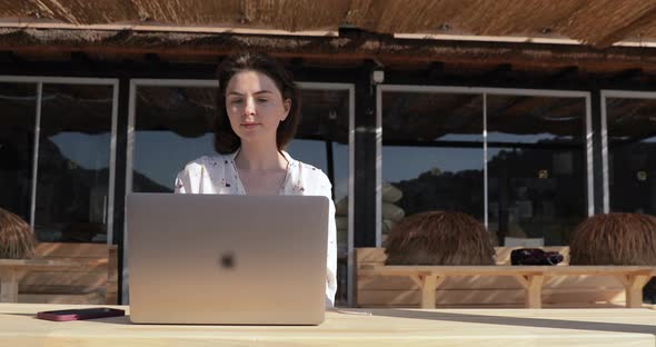 Woman working from hotel during quarantine. Girl and mobile work, doing job