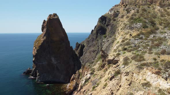 Aerial View From Above on Calm Azure Sea and Volcanic Rocky Shores