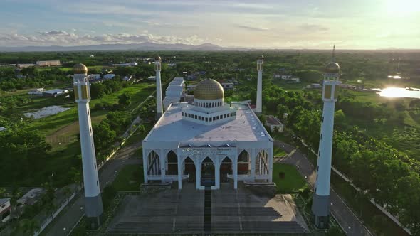 Aerial drone decending view of Central Mosque Songkhla at sunset, Thailand