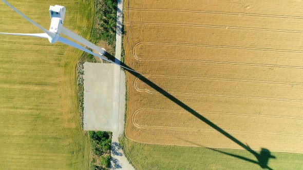 Windmill for electric power production in the agricultural fields. View from above.
