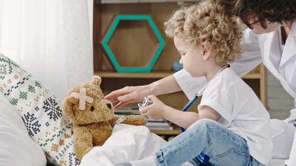 Mother and Toddler Boy Playing Doctor