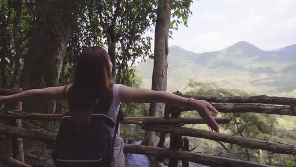 Woman Hiker Raising Hands Up On Mountain Peak