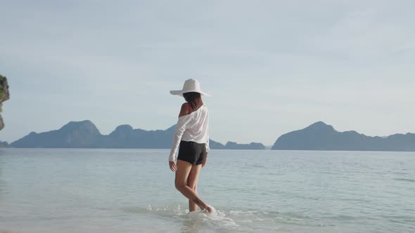 Woman Walking In Sea On Entalula Beach