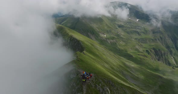 close up  aerial view of moldoveanu peak with tourists in clouds and romanian flag