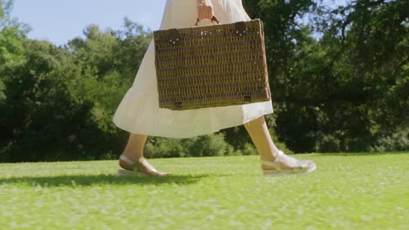 Female Feet Walking with Picnic Basket in Green Park Forest Travel Concept 6K