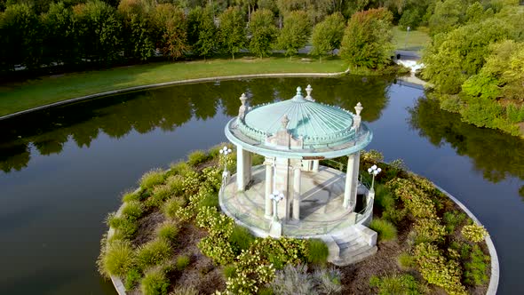 Gazebo with Stone Columns in Old Fashioned Romantic Venue Surrounded by Water - Aerial Drone Orbit E