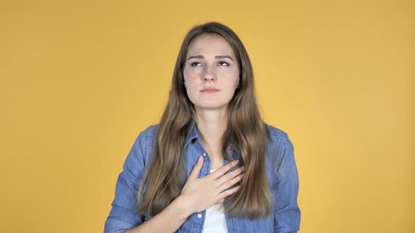 Sick Pretty Woman Coughing Isolated on Yellow Background