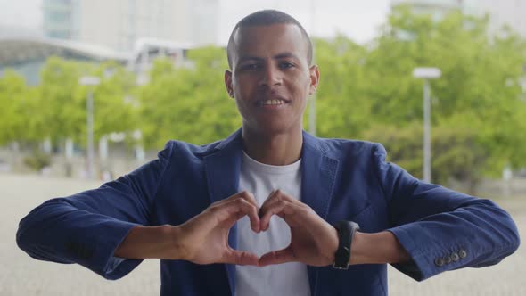 Smiling African American Man Making Heart Sign with Hands