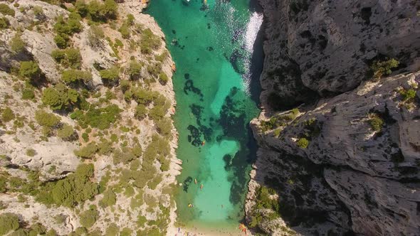 Aerial travel drone view of clear green water, cliffs of Cassis, Mediterranean Sea, Southern France.