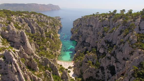 Aerial travel drone view of clear green water, cliffs of Cassis, Mediterranean Sea, Southern France.